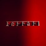 Detailed shot of a Ferrari emblem on a sleek red background, showcasing luxury automotive design. — Maximizing Your Retiremen